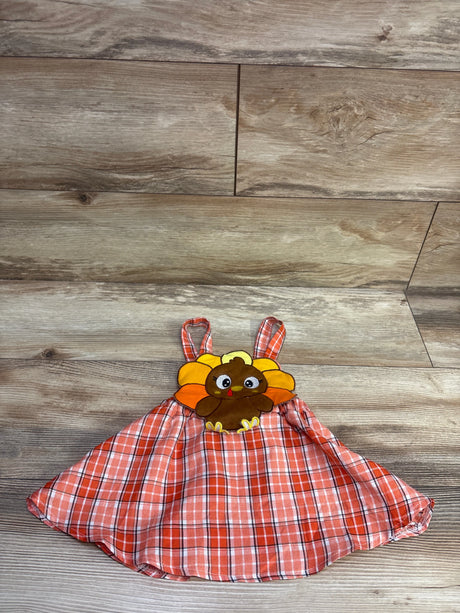 Front view of Bonangber Thanksgiving skirtall showcasing its orange plaid pattern and turkey appliqué on a wood floor