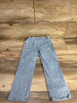 Back view of light blue Cat and Jack toddler jeans, size 5T, showing embroidered daisy on back pocket on wood floor