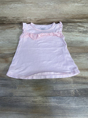Flat lay pink eyelet ruffle toddler shirt, size 12m, showing eyelet trim and flutter sleeves on light wood