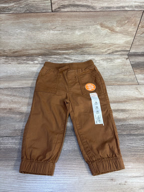 Brown boys 12-month jogger pants with elastic waist, drawcord, reinforced knees, laid on wood floor