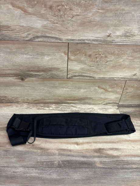Top view of Senerah Sling Carrier showcasing its black padded waist panel and buckle straps on a wood floor