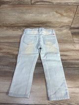 Back view of Lucky Brand Zoe toddler jeggings (2T) showcasing rear patch pockets and faded wash on wood floor background