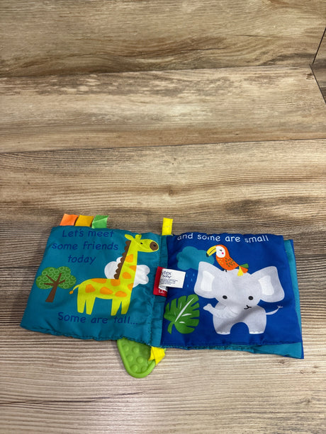 Open view of Jungle Friends cloth crinkle book showcasing giraffe and elephant pages with green textured teether on wood
