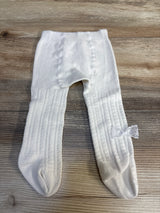 White baby tights with lace bow, ribbed texture, laid on wood floor — kids clothing resale
