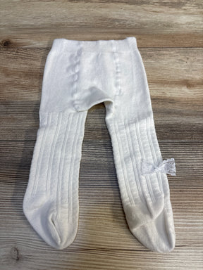 White baby tights with lace bow, ribbed texture, laid on wood floor — kids clothing resale