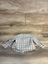 Plaid long sleeve toddler shirt in neutral colors on wood background