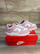 Side view of toddler Nike Dunk Low 'Pink Glaze' sneakers, size 8C; pink and white leather with white laces on a red Nike box