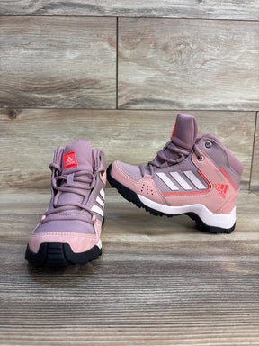 Pink Adidas kids high-top sneakers with white stripes and rugged soles on wood background