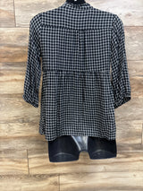 Front view of Isabel Maternity flannel popover tunic with long sleeves and black plaid pattern on wood flooring