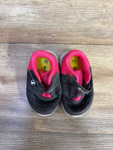 Top view of Champion toddler sneakers, gray knit with pink lining and velcro strap, size 3W on yellow insoles on wood floor