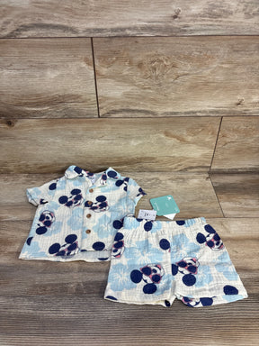 Baby Disney-themed short sleeve shirt and shorts set with Mickey Mouse sunglasses print on wood floor
