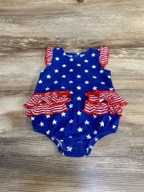 Top-down view of Baby Starters blue 9m romper with white stars and red-striped ruffle details on wood background