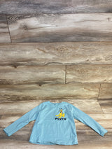 Light blue long sleeve kids shirt with cartoon dog graphic and Pluto text on wood floor