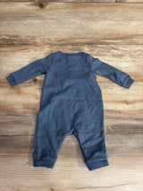 Blue long sleeve baby romper laid flat on wooden floor, gently used children's clothing