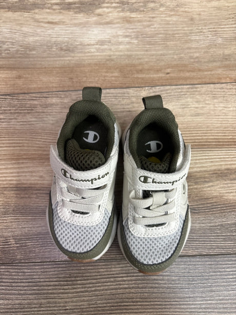 Top view of Champion Hyper V2 Next sneakers, size 5C, in white and green, showcasing mesh uppers and laces on wood flooring