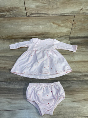 Light pink long sleeve baby dress and matching bloomers with small daisy print on wood floor