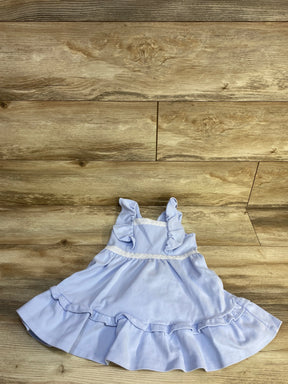 Top-down view of light blue girls' dress (3T) with ruffled straps, lace waist trim and ruffled hem on wood floor