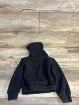 Black kids hooded sweatshirt with ribbed cuffs laid flat on wood floor