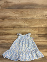 Flat lay of NEW Nannette Floral Sleeveless Dress sz 4T showcasing blue daisy print with ruffled hem on wood plank floor