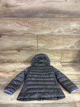 Grey Nike hooded puffer jacket for toddlers laid flat on a wood background