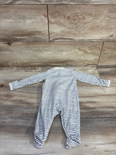 Flat lay of Little Planet organic striped footed sleeper showing thin navy stripes on white cotton with wood plank background