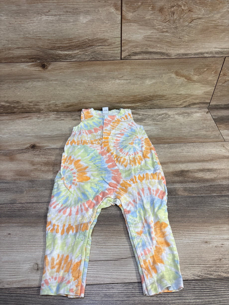 Flat-lay of toddler tank romper (18-24 months) showing front snap closures and pastel tie-dye on wood background