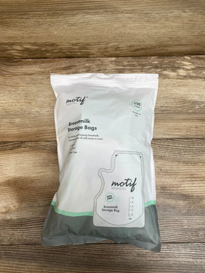 Top view of Motif Medical breastmilk storage bags package showing 100-count badge and BPA-free icon on wood background