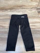 Black toddler leggings with back pockets on wood floor, gently used kids clothes