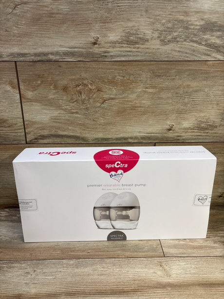 Front view of Spectra Premier wearable electric breast pump boxed set showing twin wearable pumps on white packaging against wood floor