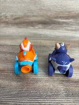 Rear view of two small colorful children's toy cars on wooden surface, one orange and blue, the other purple and white