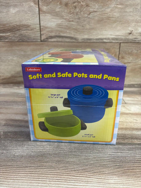 Front view of Lakeshore Soft and Safe Pots and Pans box showing blue and green pots with lids and size markings
