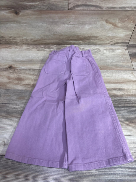 Rear view of Nordstrom wide-leg pants in lavender, size 4T, showcasing elastic waist and two back pockets on a wood floor