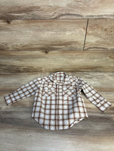 Front flat lay of Wrangler toddler snap front western shirt in beige plaid with chest flap pockets on wood background