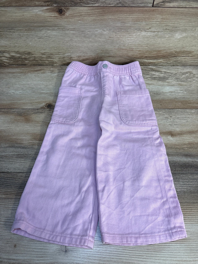 Light purple kids shorts with elastic waist and side pockets, laid on wood floor