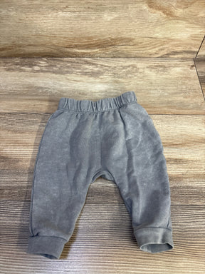 Front flat lay of newborn grey Cat and Jack pull-on joggers showing elastic waistband and cuffed ankles on wood background