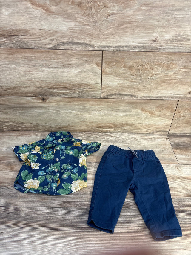 Top-down flat lay of Old Navy newborn 2-piece navy set showcasing floral button-up shirt and elastic-waist navy pants on wood floor