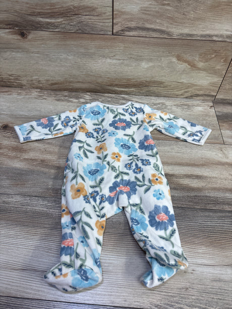 Front view of Child of Mine white blanket sleeper in size 0-3m, showcasing floral print and enclosed feet on a wood floor