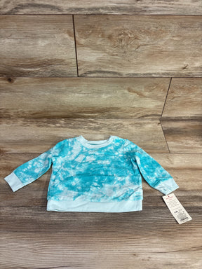 Aqua blue tie-dye long sleeve baby shirt with tag, displayed on wood background