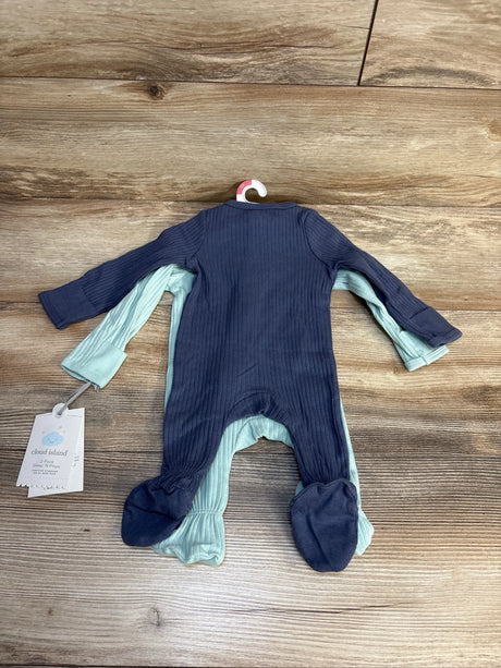 Two ribbed baby footed sleepers, one navy and one light blue, on wooden surface.