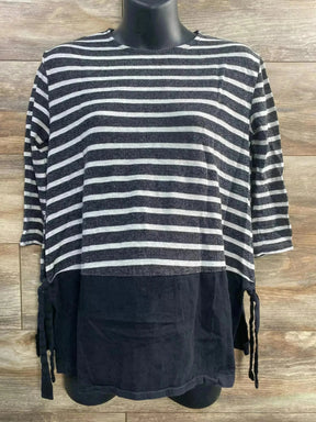 Front view of ASOS maternity striped top with black lower panel and side ties on a mannequin against wood background