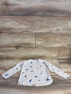 White and gray striped long sleeve shirt with blue and brown animal prints on wooden background
