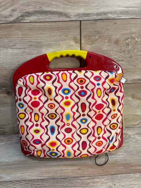 Front of B. Toys LapTrec drawing board showing red plastic top, yellow handle and colorful fabric cover on wood background