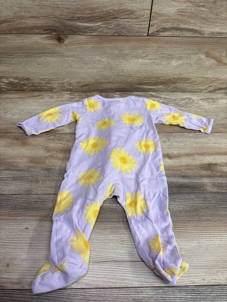 Front view of Just One You purple sleeper showcasing yellow sunflower pattern and footed legs on a wood surface