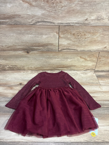 Flat-lay of Cat and Jack burgundy long-sleeve dress with sparkly ribbed bodice and layered tulle skirt on wood floor