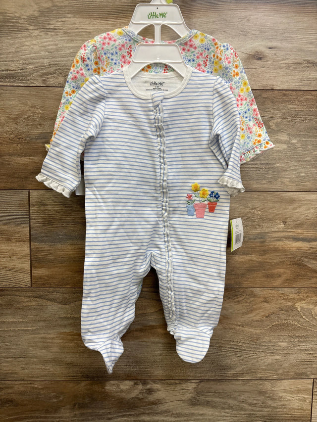 Front view of Little Me 2-pack ruffle footed sleepers: blue-white striped with flower embroidery, and floral print, on wood