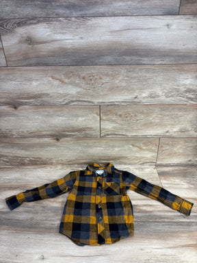 Children's long-sleeve flannel shirt in yellow, black, and gray plaid on wood floor