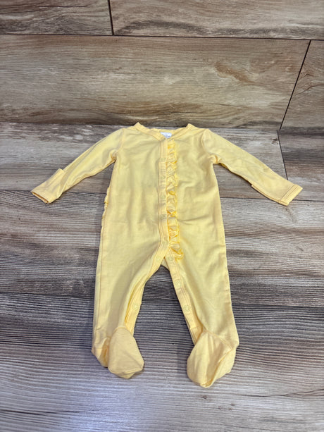 Front view of yellow newborn ruffle snap sleeper showcasing long sleeves, footed legs, and front snaps on a wood-patterned background
