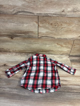 Flat lay of H&M red plaid button-up flannel shirt in size 6 months showcasing long sleeves with a wood background