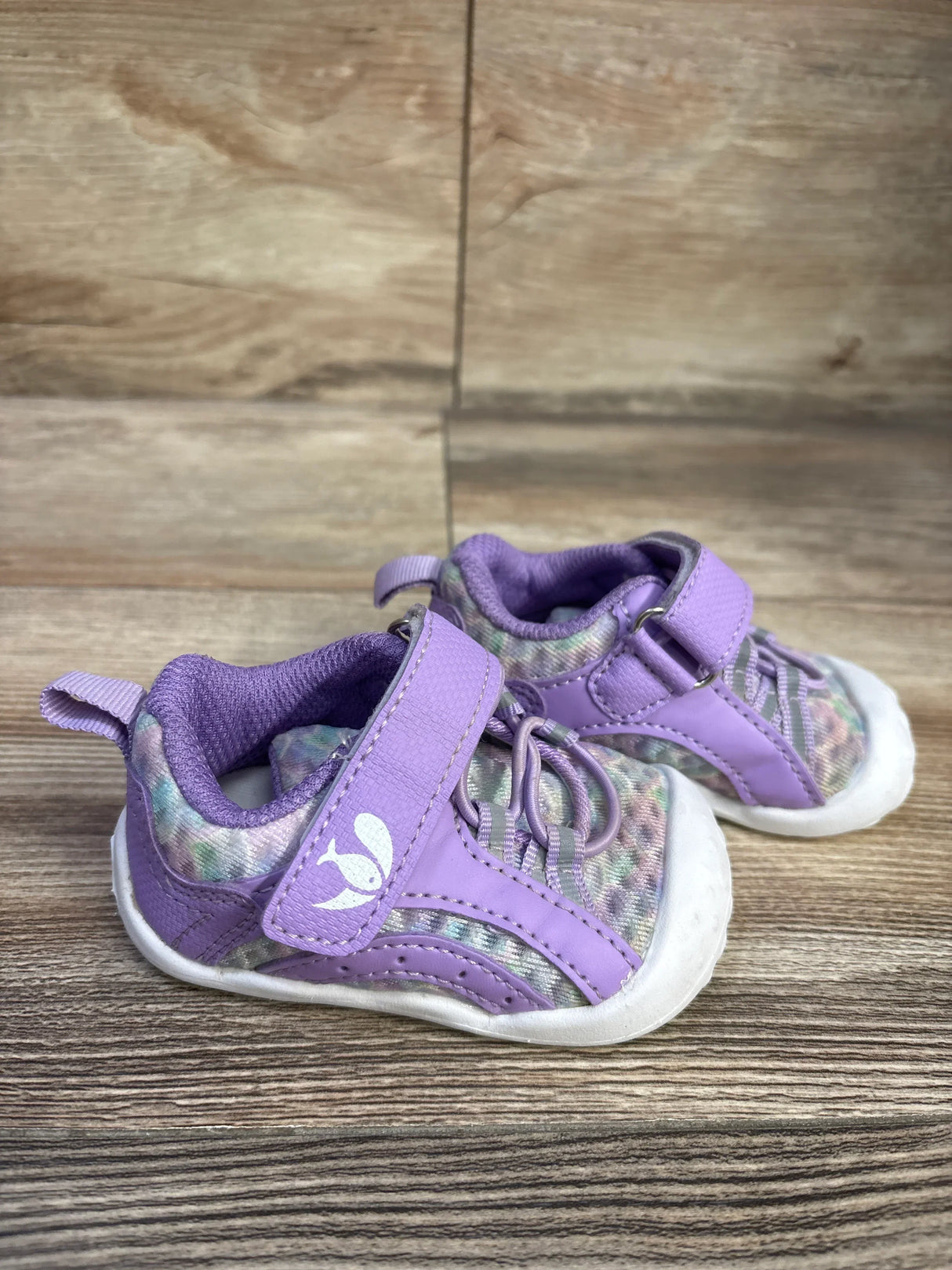 Side view of FEETCITY toddler purple wide barefoot water shoes showing Velcro strap, mesh upper, and white sole on wood floor