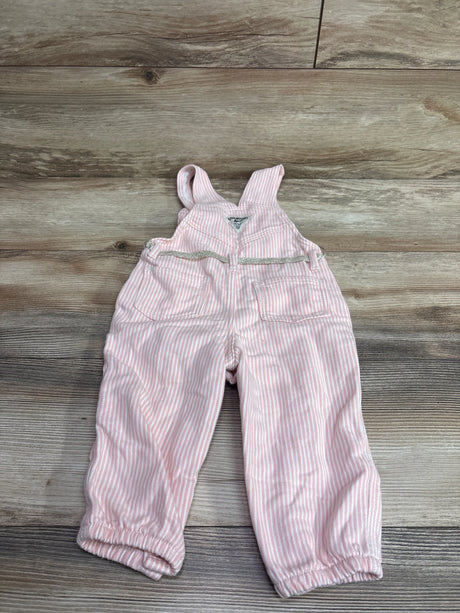 Pink and white striped baby overalls by Me n Mommy To Be on a wooden surface.